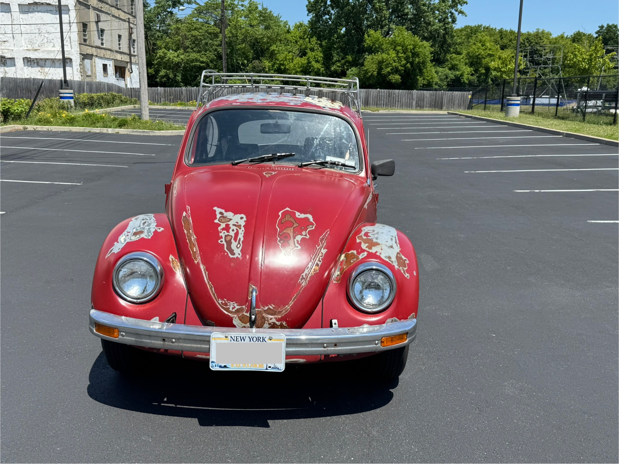 Front view of 1968 VW Beetle showing iconic headlights and patina finish